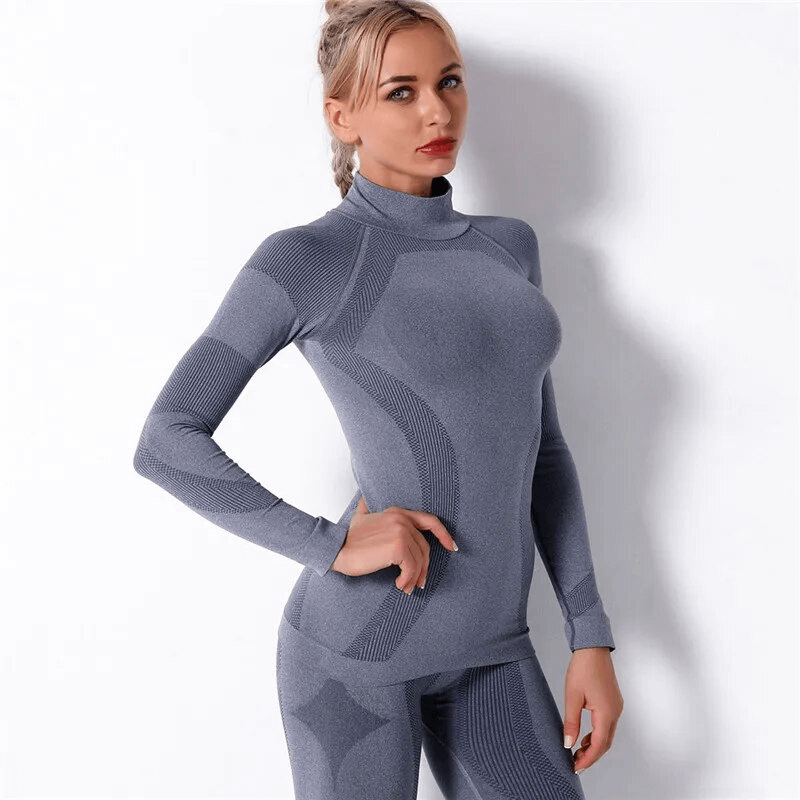 Woman wearing a stretchy seamless super soft long sleeves sports top in gray, perfect for yoga and other athletic activities.